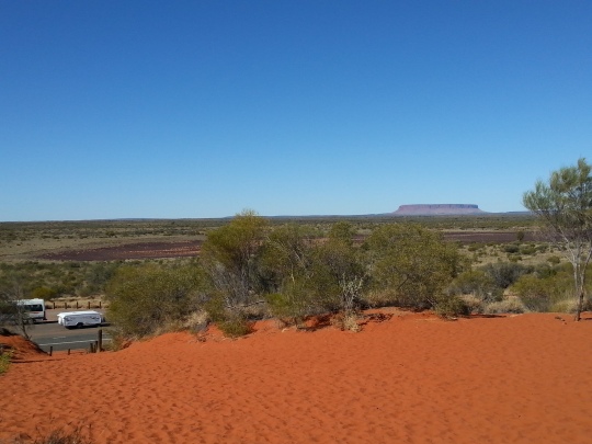 The most amazing red dirt everywhere you look here in Central Australia. Mt. Connor in the background and our van down the bottom of the hill. 
